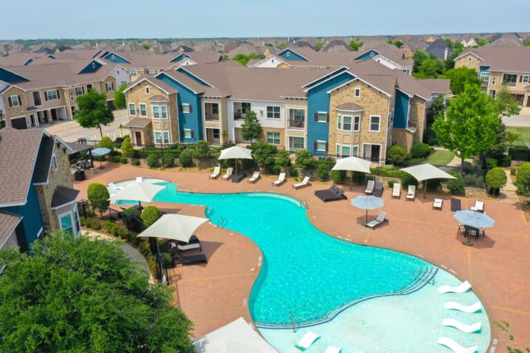 Windsong Estates Apartments resort-style pool aerial photo.